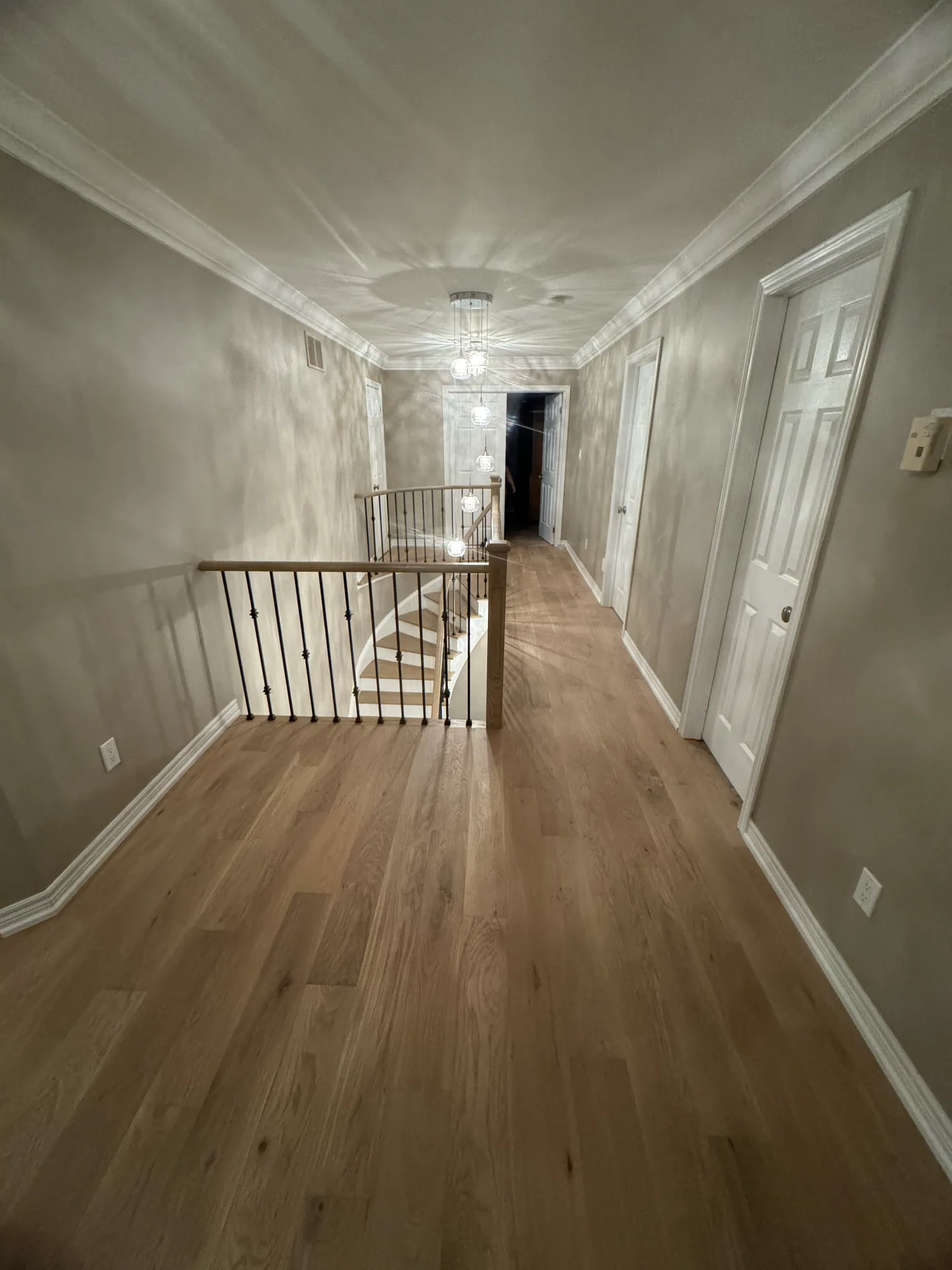 Upstairs landing in wide plank white oak matching the staircase treads in a Bolton home