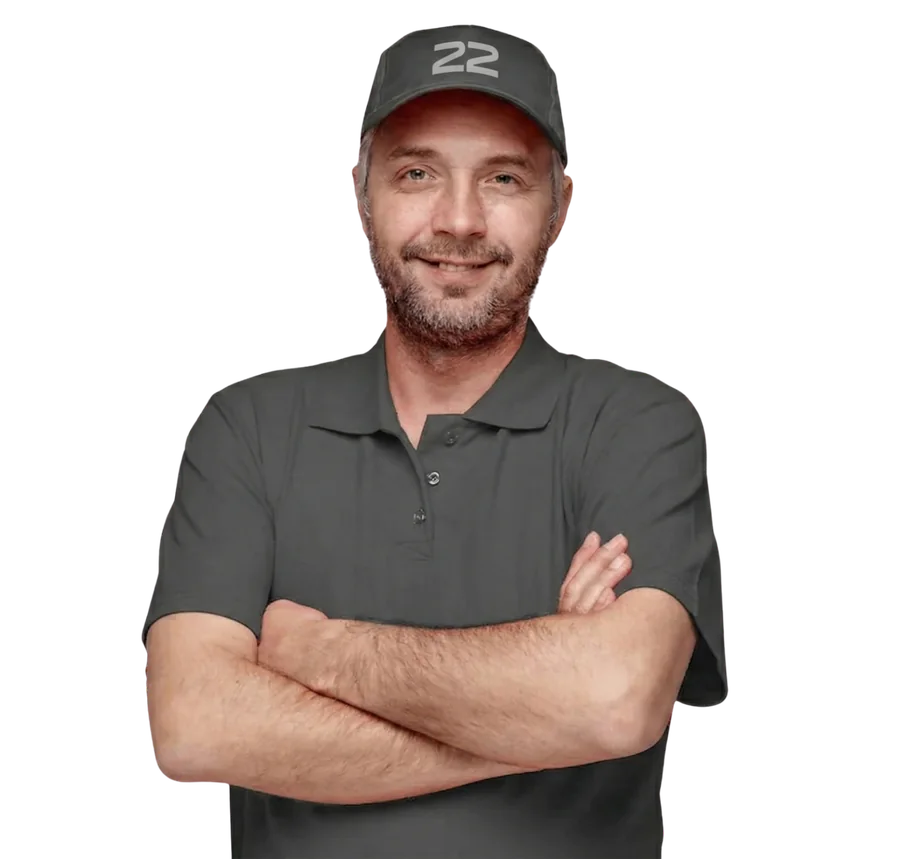 Smiling installer in a grey 22 cap and polo, arms crossed