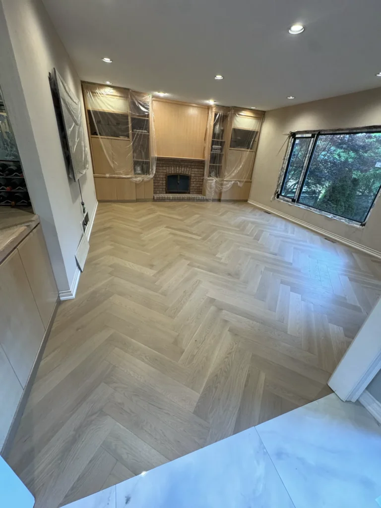 Herringbone white oak floor laid through a Richmond Hill living room