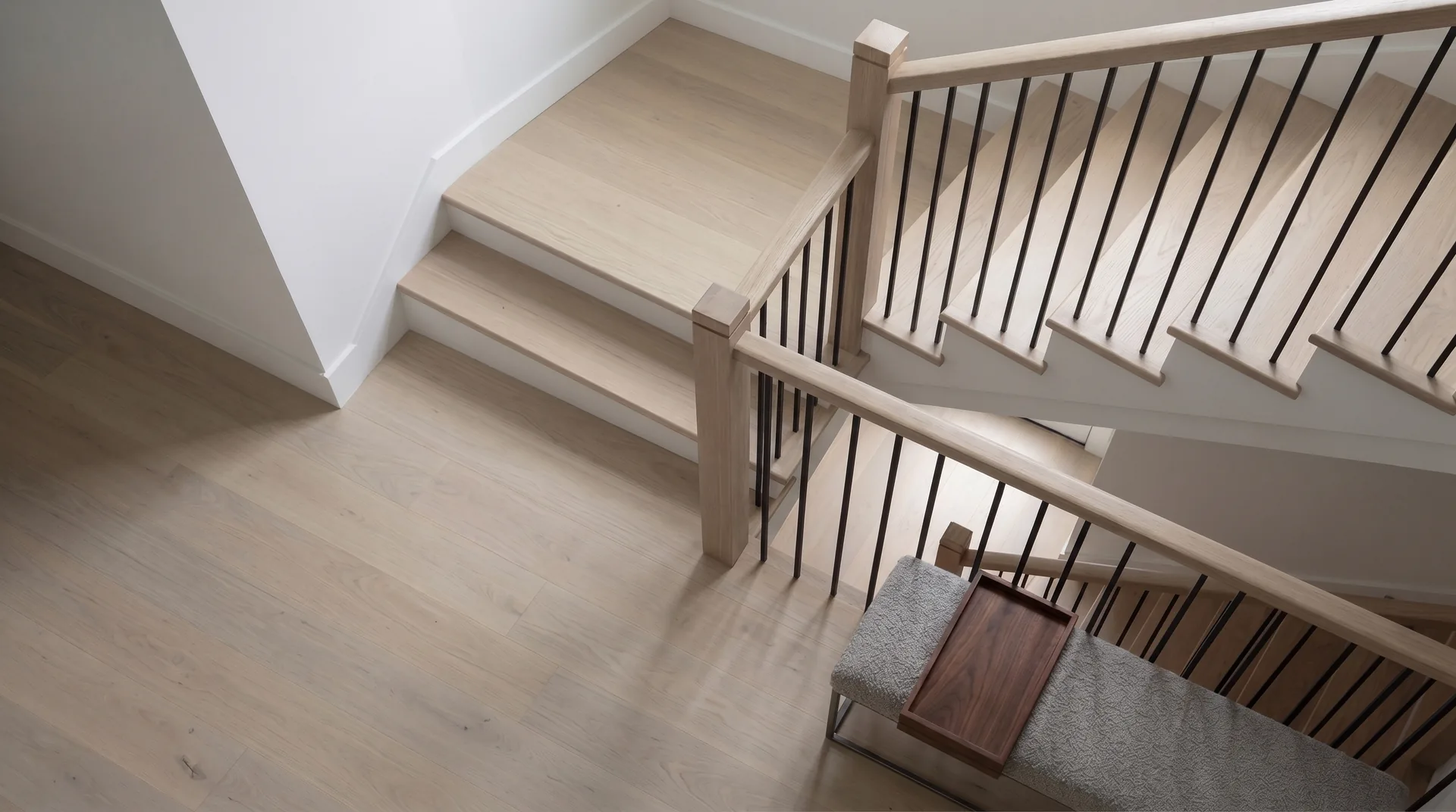 Staircase remodelled in white oak with square oak posts and black metal spindles, Toronto