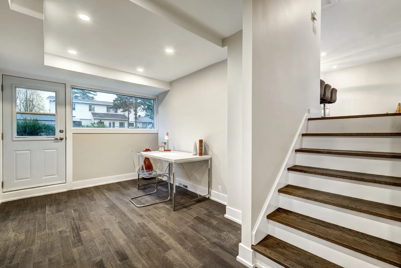 Vinyl plank stairs with dark treads and white risers beside a vinyl plank floor in a Toronto home