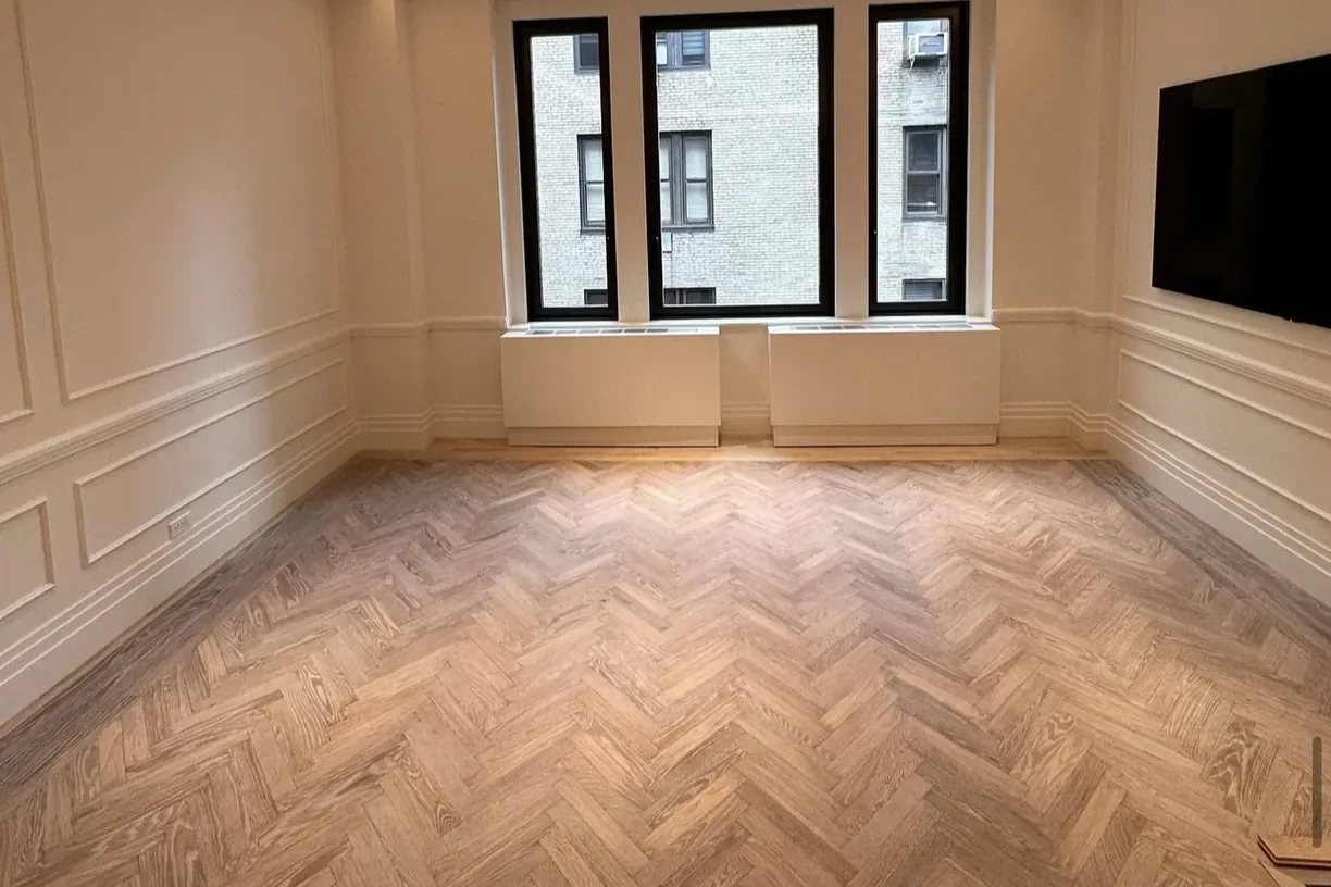 Light herringbone oak floor in a downtown Toronto condo living room with black window frames