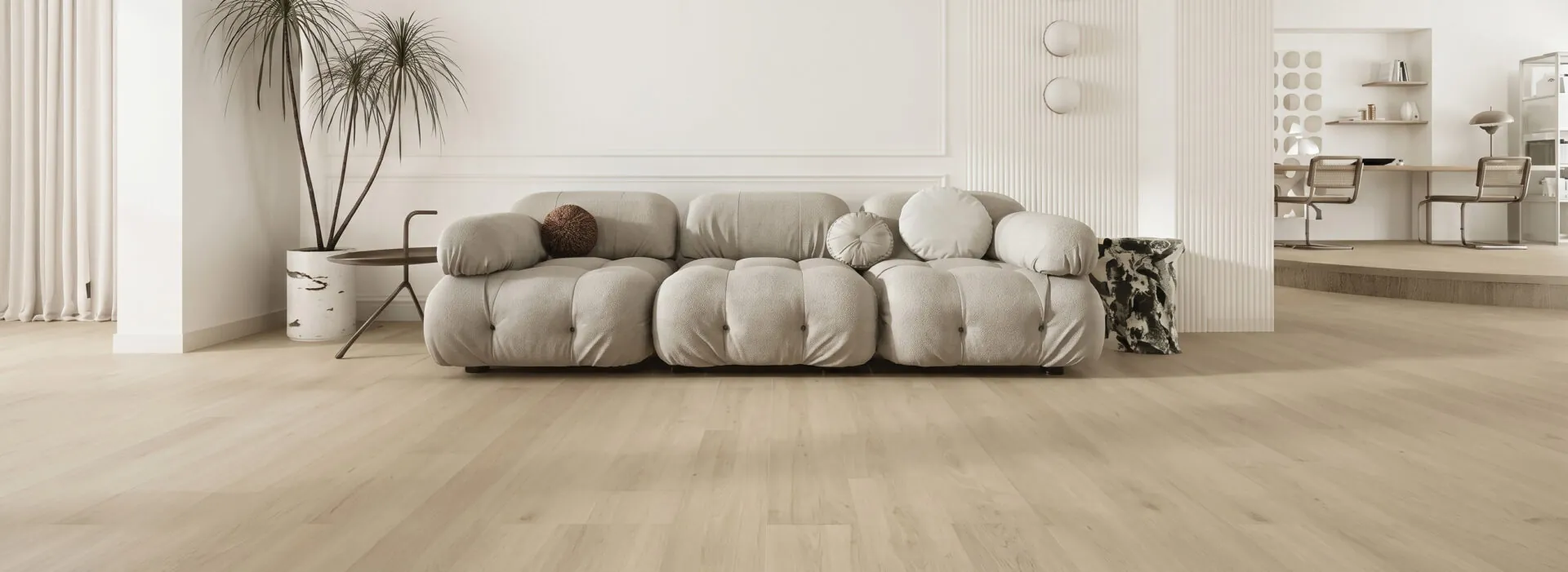 Light oak wide-plank floor in a bright living room with sofa