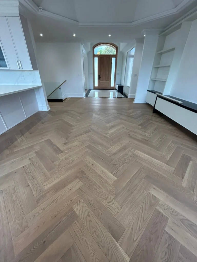 White oak herringbone hardwood running through a Toronto living room to the front door