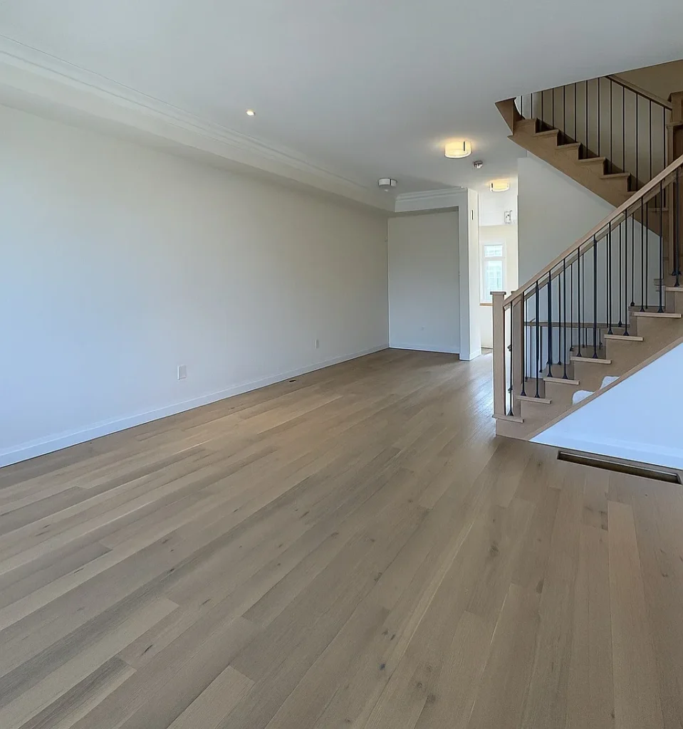 Light oak hardwood in a Toronto living room next to an oak staircase