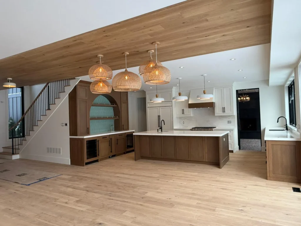 Natural light oak hardwood floor in an open Toronto kitchen with rattan pendant lights