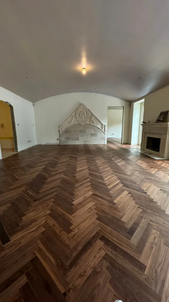 Walnut herringbone hardwood floor in a Toronto living room with a vaulted ceiling